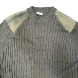 A close-up of a ribbed knit sweater in heather gray with muted olive-green shoulder panels, shown against a plain white background.