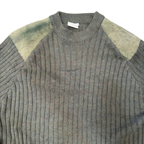A close-up of a ribbed knit sweater in heather gray with muted olive-green shoulder panels, shown against a plain white background.